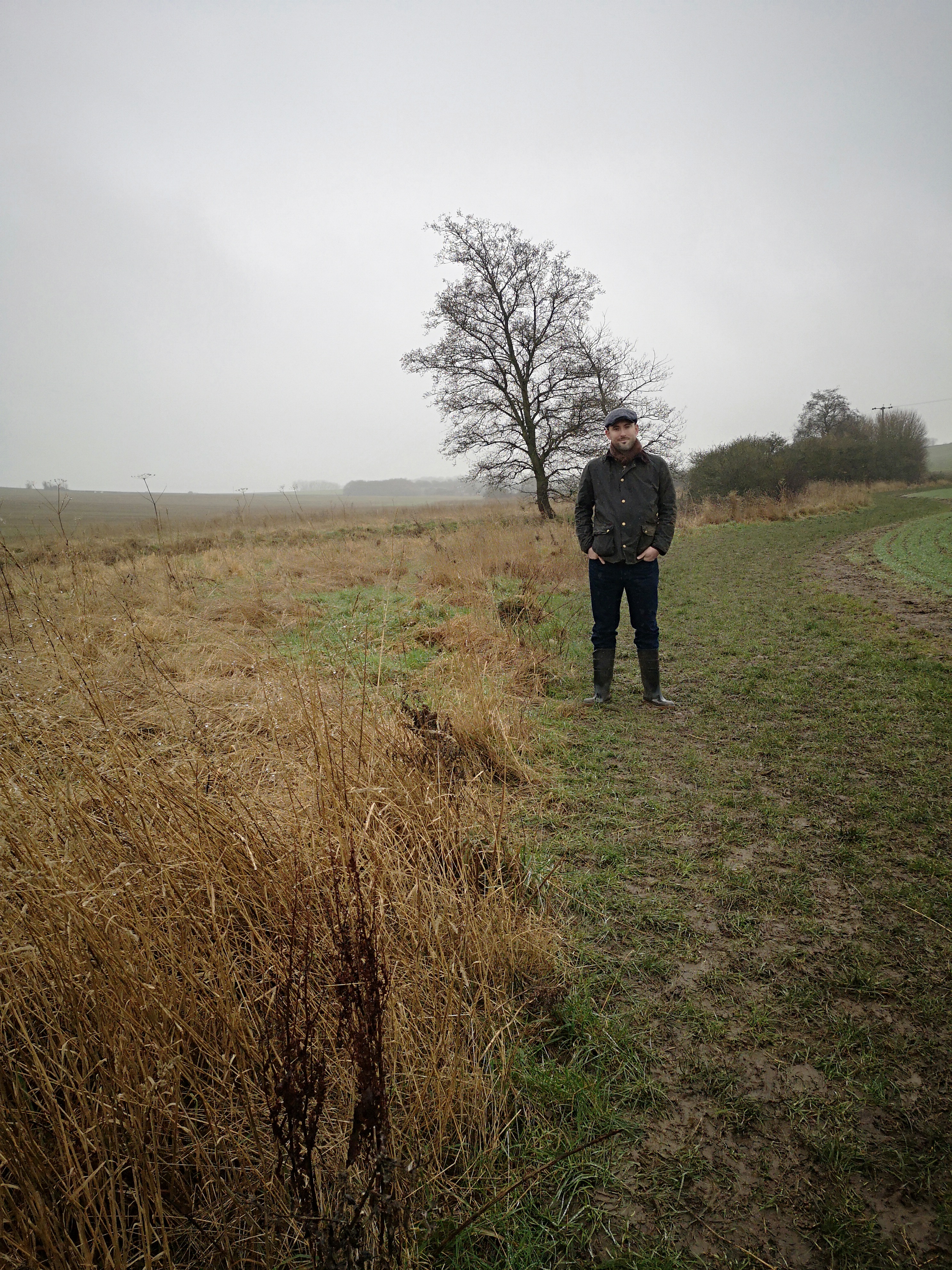Image of Alister standing in the middle of a field